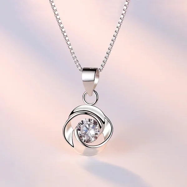 Sterling silver necklace pendant featuring a spiral design and cubic zirconia stone