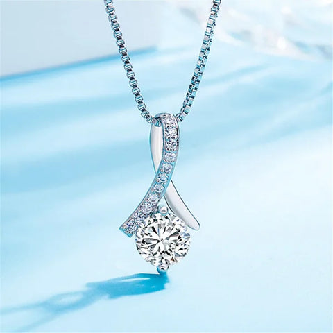 Elegant sterling silver necklace with twisted pendant, diamonds, and central zircon stone