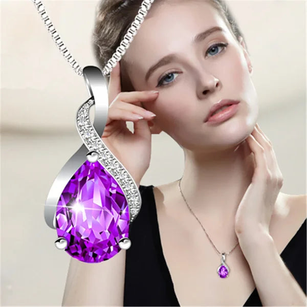 Teardrop-shaped purple amethyst pendant with diamond accents on a sterling silver necklace