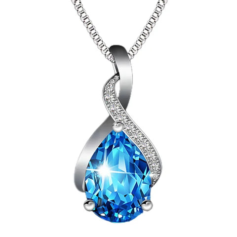 Teardrop-shaped blue gemstone pendant on sterling silver necklace with diamond accents