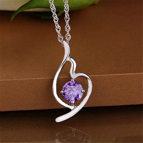 Silver heart-shaped pendant necklace featuring a purple crystal, perfect sterling silver necklace