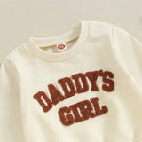 Cream-colored baby sweatshirt with Daddys Girl fuzzy text in stylish infant clothing set