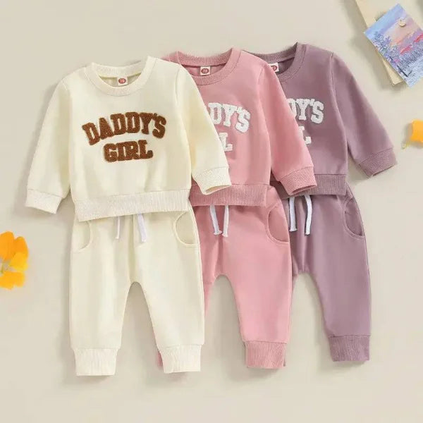 Three stylish infant clothing sets in cream, pink, purple for comfort