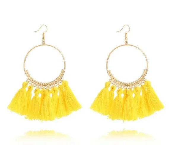 Stylish round drop dangle earrings featuring gold hoops and bright yellow tassels