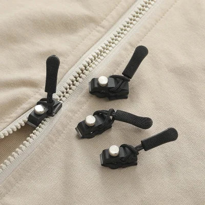 Black zipper pulls with rubber grips on a white zipper for zipper head repair