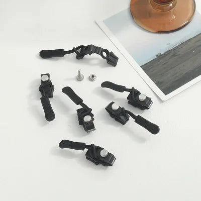 Collection of black camera mounting clamps and hardware for universal zipper repair device